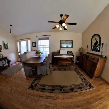 a living room with furniture a fireplace and potted plants