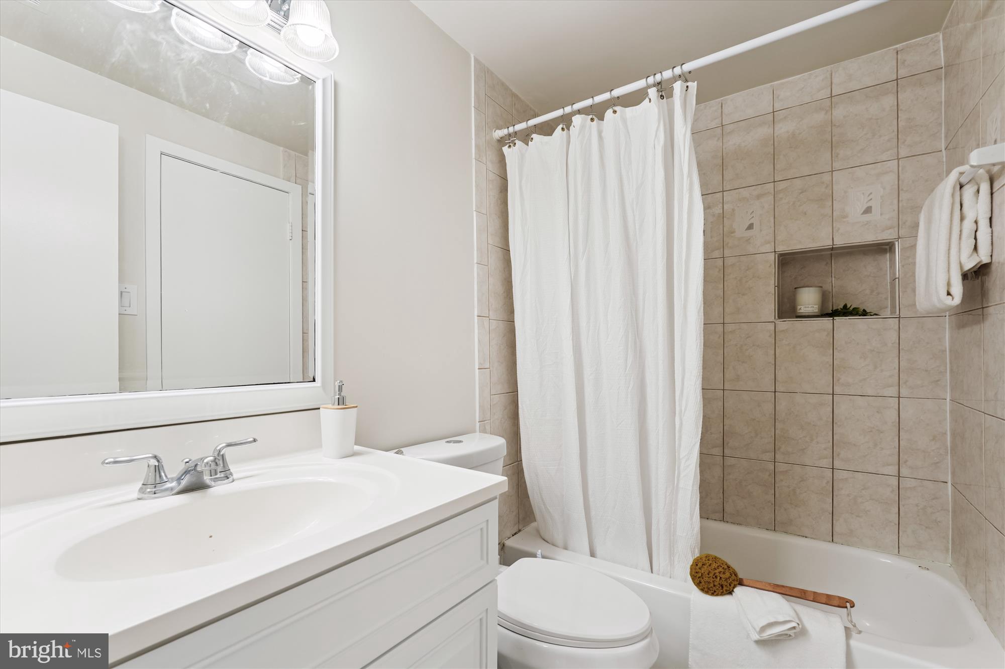 9731 Hellingly Place, Unit 37 Montgomery Village, MD 20886 - Photo 15 of 20 a bathroom with a sink toilet and shower