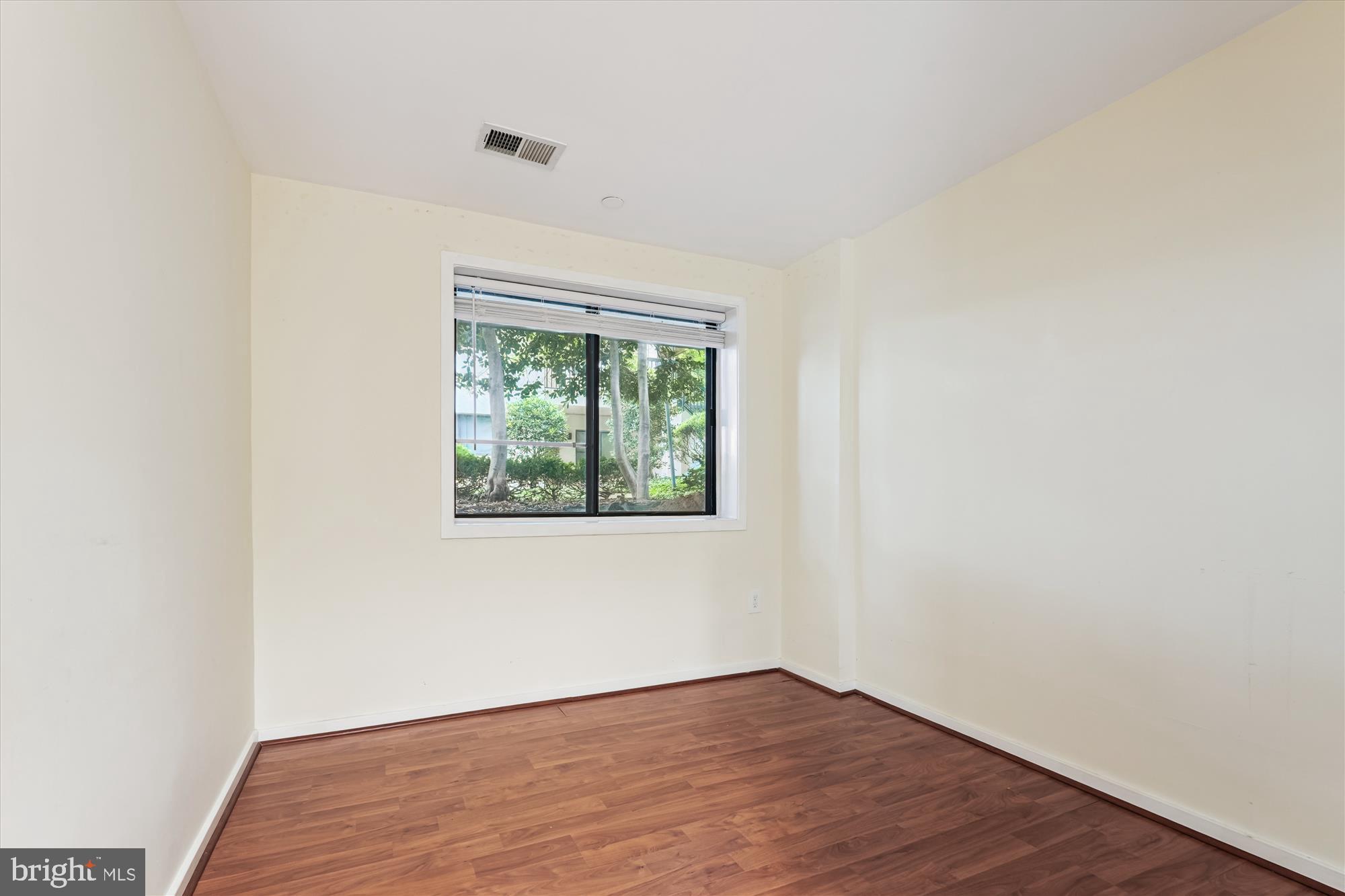 9731 Hellingly Place, Unit 37 Montgomery Village, MD 20886 - Photo 17 of 20 an empty room with wooden floor and window
