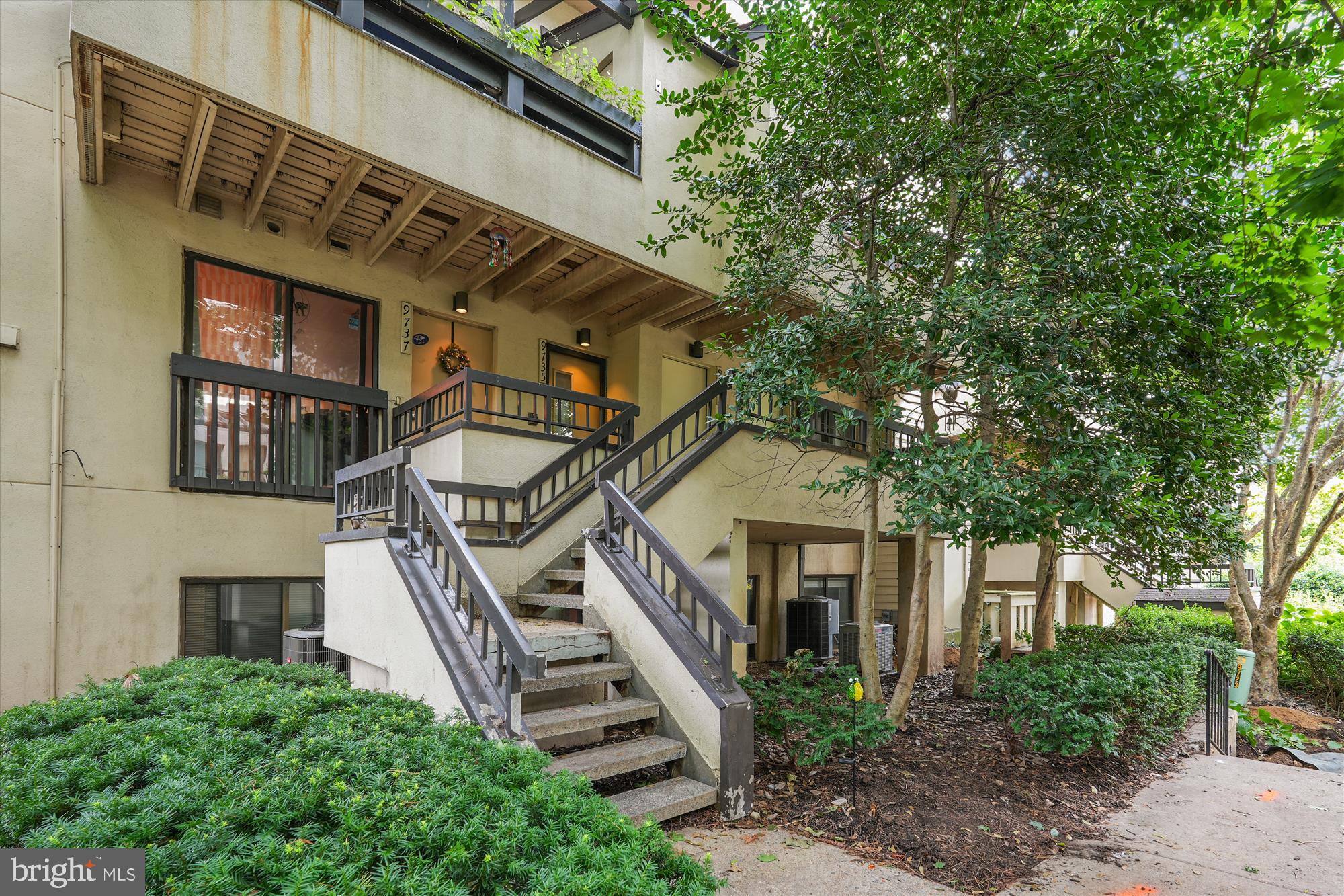 9731 Hellingly Place, Unit 37 Montgomery Village, MD 20886 - Photo 20 of 20 a front view of a house with a small garden