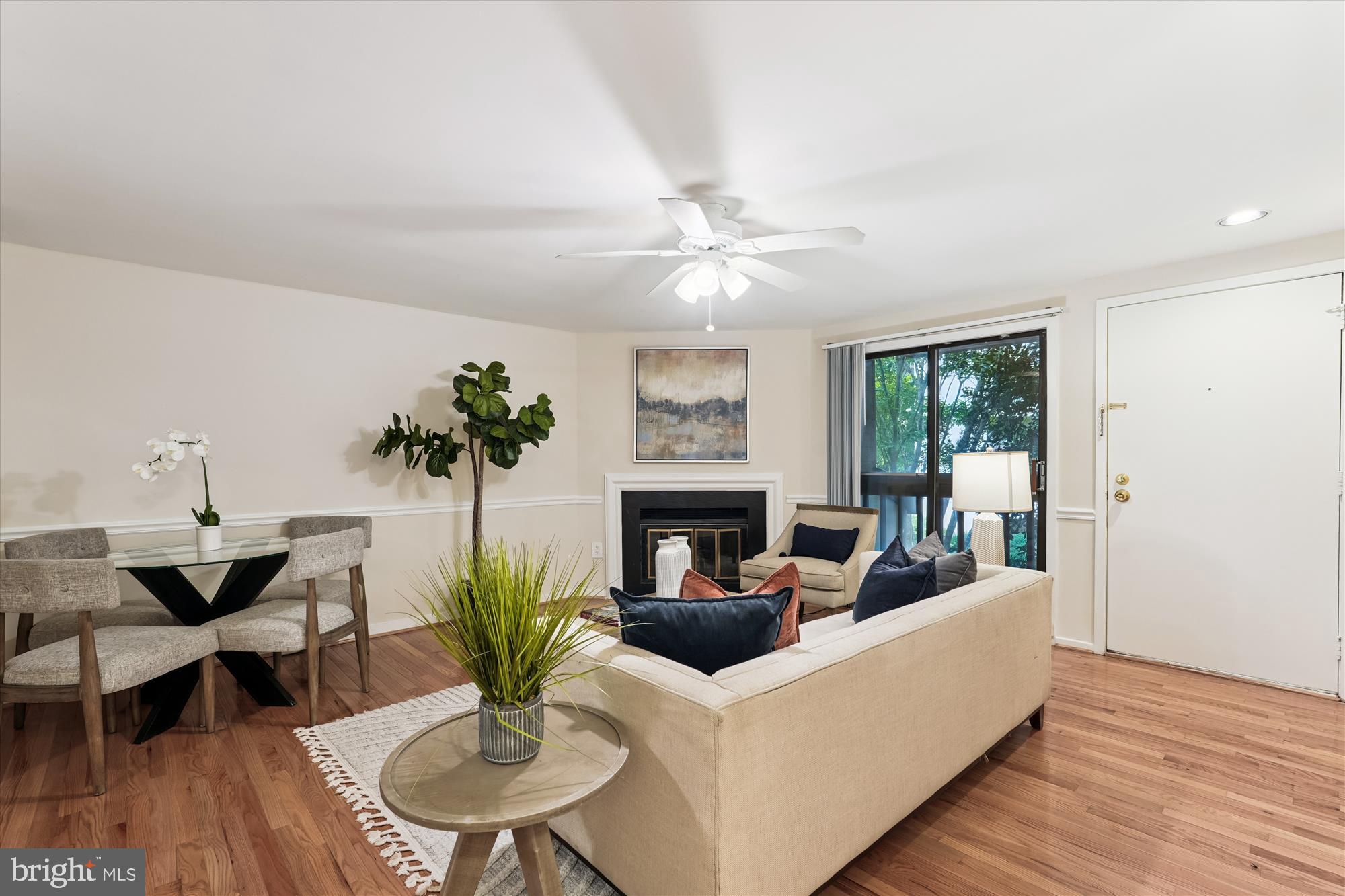 9731 Hellingly Place, Unit 37 Montgomery Village, MD 20886 - Photo 3 of 20 a living room with furniture a chandelier and a fireplace