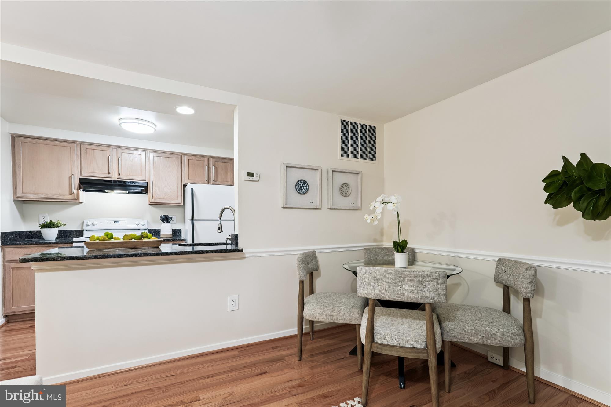 9731 Hellingly Place, Unit 37 Montgomery Village, MD 20886 - Photo 4 of 20 a kitchen with stainless steel appliances a table and chairs in it