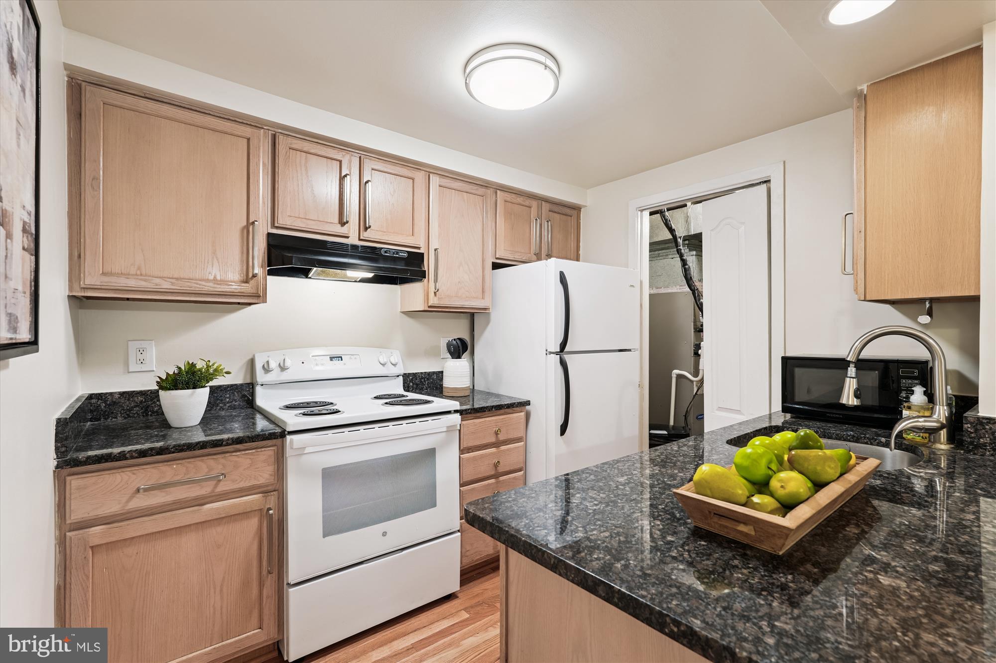 9731 Hellingly Place, Unit 37 Montgomery Village, MD 20886 - Photo 8 of 20 a kitchen with granite countertop a refrigerator stove and sink