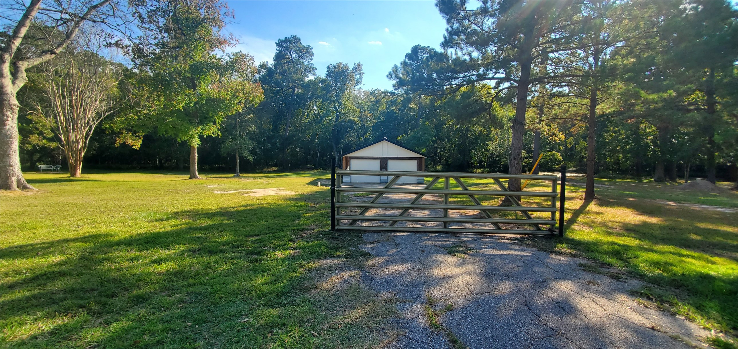 302 Waterfall Drive Huffman, TX 77336 - Photo 11 of 17 a view of a bench in a backyard