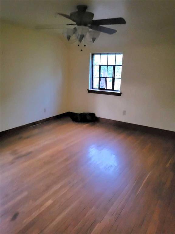 1003 Maple Avenue Turtle Creek, PA 15145 - Photo 11 of 24 an empty room with wooden floor and windows