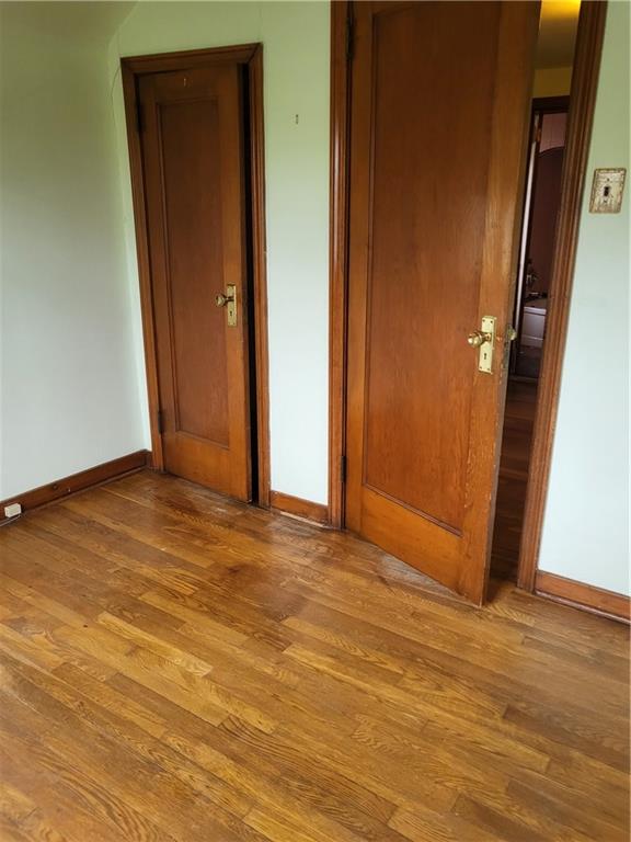 1003 Maple Avenue Turtle Creek, PA 15145 - Photo 13 of 24 an empty room with wooden floor and entrance