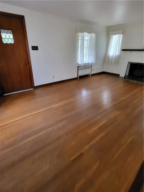 1003 Maple Avenue Turtle Creek, PA 15145 - Photo 2 of 24 an empty room with wooden floor and windows