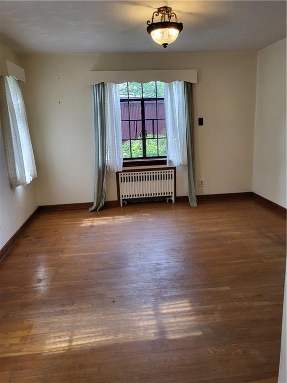 1003 Maple Avenue Turtle Creek, PA 15145 - Photo 6 of 24 a view of room with window and hardwood floor