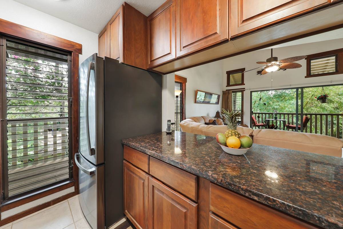 2721 Poipu Road, Unit 133 Koloa, HI 96756 - Photo 7 of 18 a kitchen with a sink a counter top space and living room
