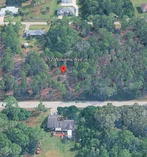 an aerial view of residential house with outdoor space and trees around