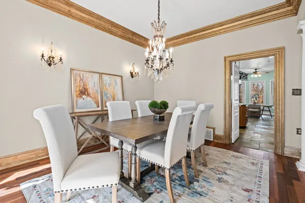 a view of a dining room with furniture and chandelier