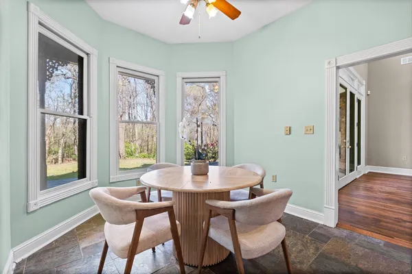 a dining room with furniture and window