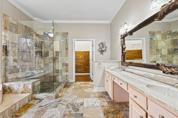 a spacious bathroom with a double vanity sink toilet and shower