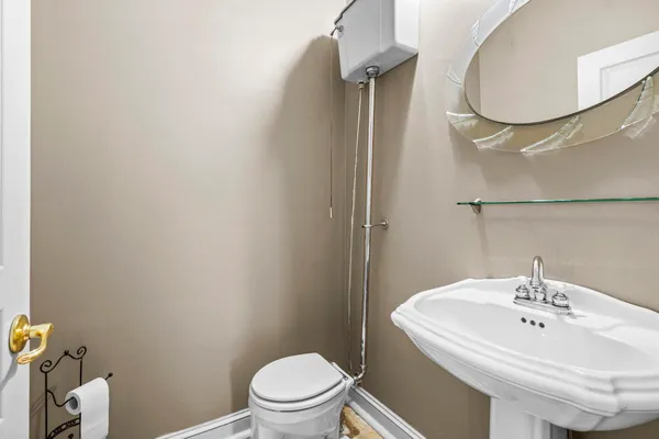 a bathroom with a sink a toilet and a mirror