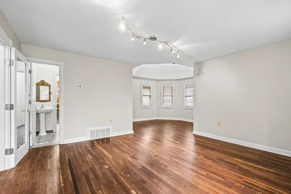 wooden floor in an empty room with a window