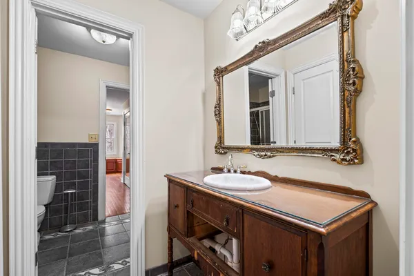 a bathroom with a sink vanity and a mirror