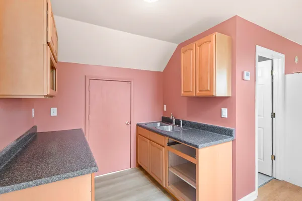 a kitchen with stainless steel appliances granite countertop a sink a stove and a microwave oven