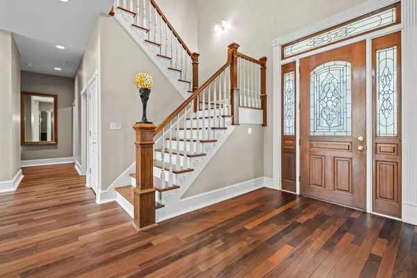 a view of entryway and hall with wooden floor