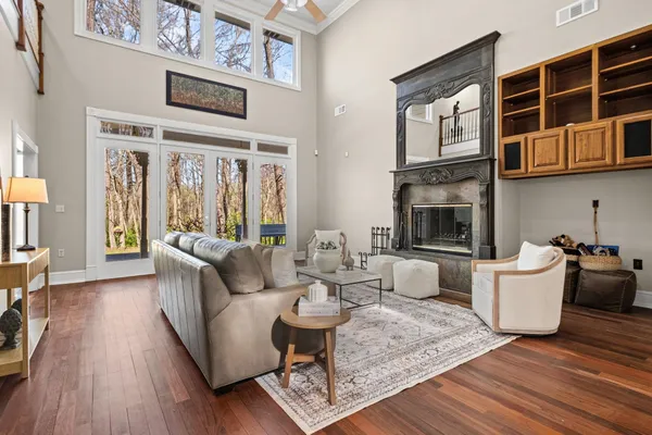 a living room with fireplace furniture and a wooden floor