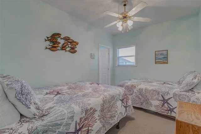 a bedroom with double bed and a chandelier