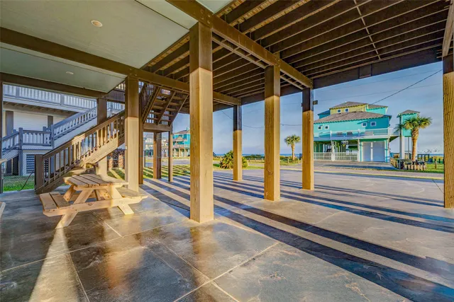 a bench is sitting in front of a house with a yard