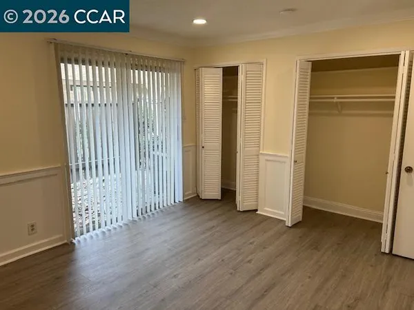 an empty room with wooden floor
