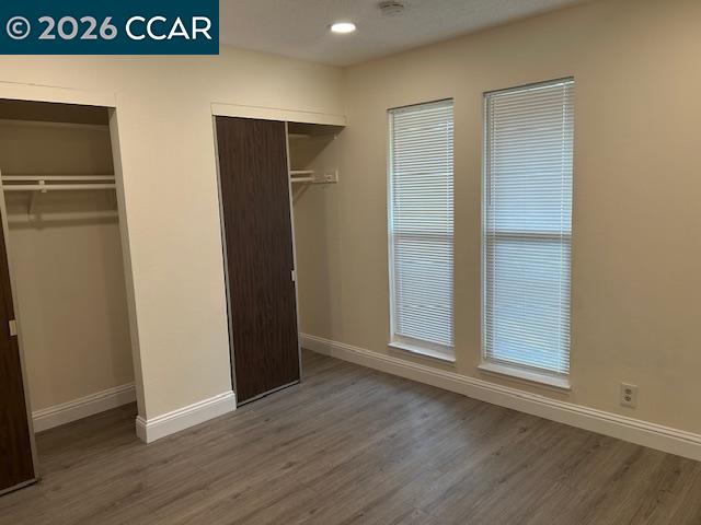 5451 Roundtree Place, Unit F Concord, CA 94521 - Photo 12 of 19 an empty room with wooden floor