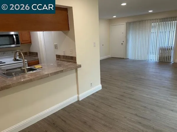 a kitchen with a sink refrigerator and microwave