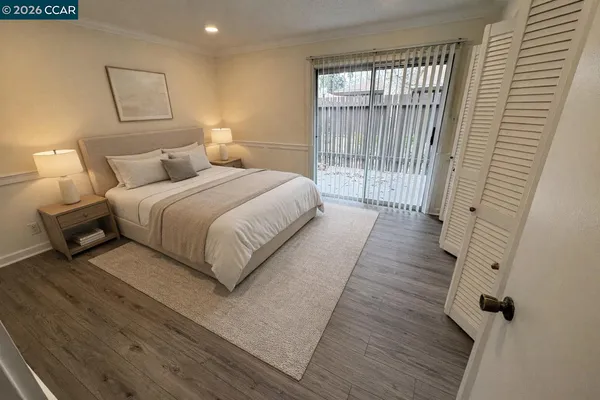 an empty room with wooden floor and closet