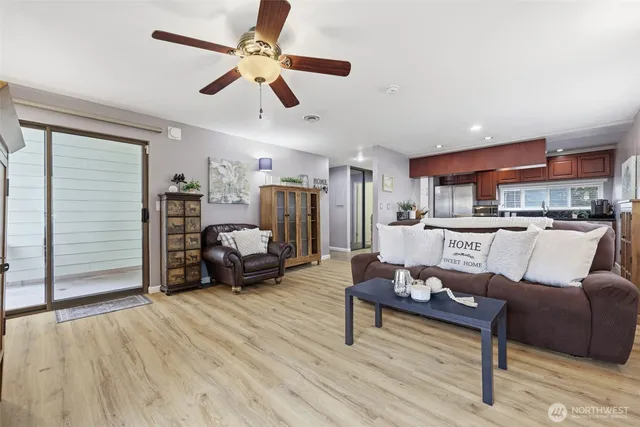 a living room with furniture and kitchen view