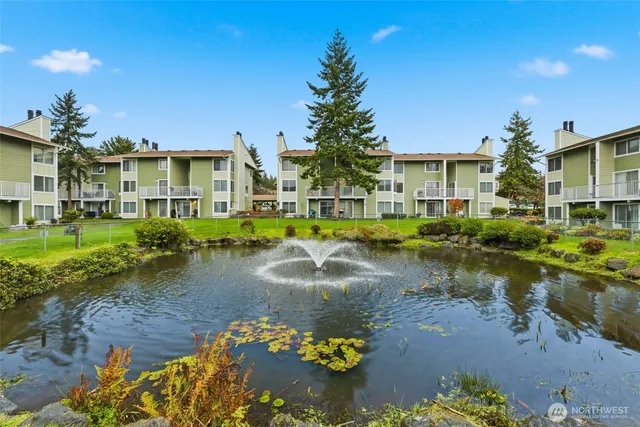 a view of residential house with outdoor space and lake view