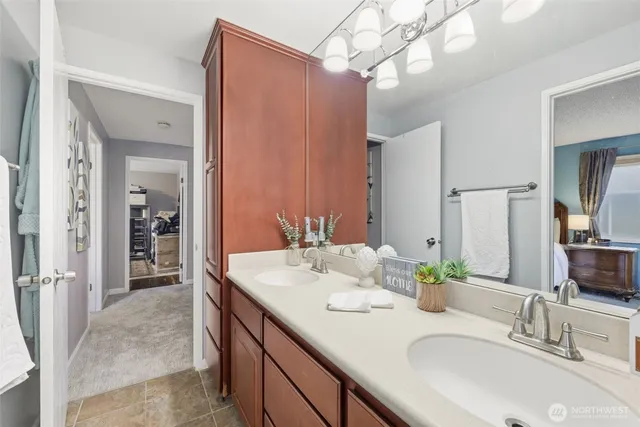 a bathroom with a double vanity sink and a mirror