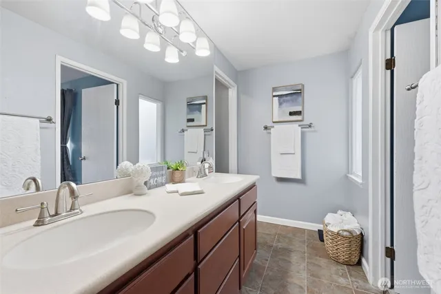 a bathroom with a sink double vanity and a mirror