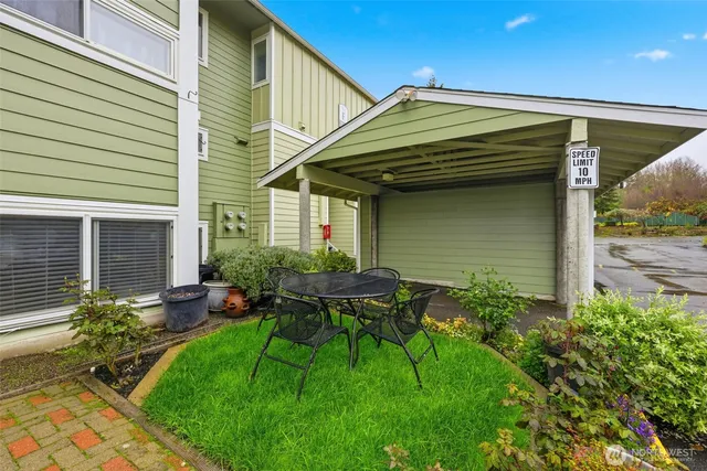 a view of house with backyard and outdoor seating