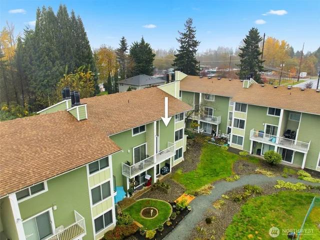 a view of a house with a yard and potted plants