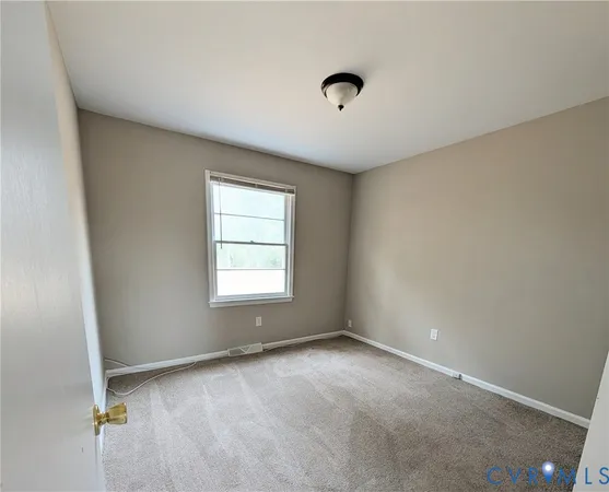 an empty room with a empty space and windows