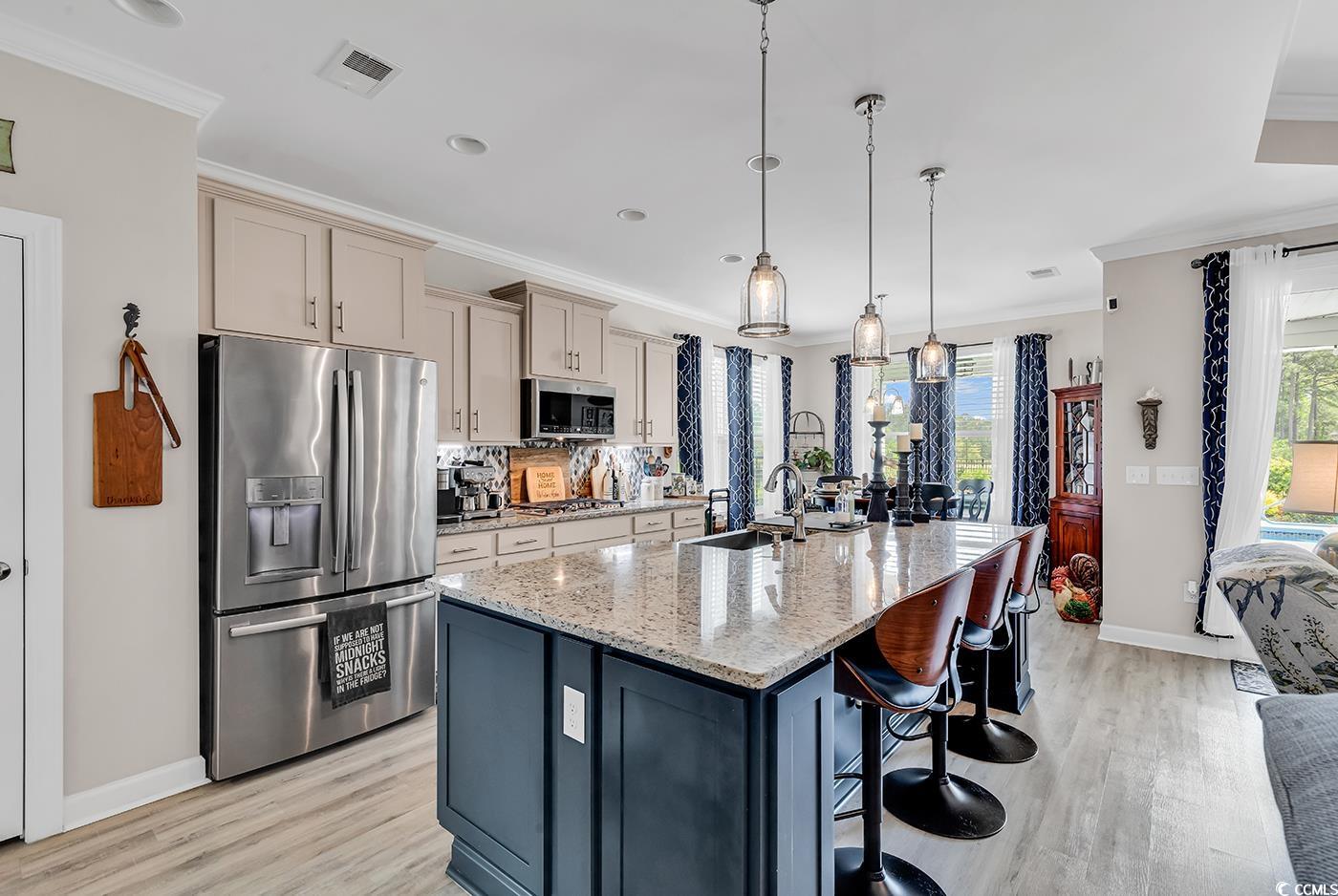 296 Switchgrass Loop Little River, SC 29566 - Photo 14 of 40 Kitchen featuring light wood-style flooring, ornam