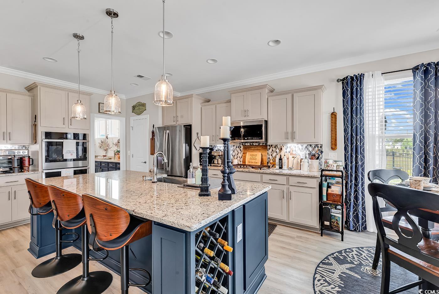 296 Switchgrass Loop Little River, SC 29566 - Photo 15 of 40 Kitchen with decorative backsplash, light wood fin