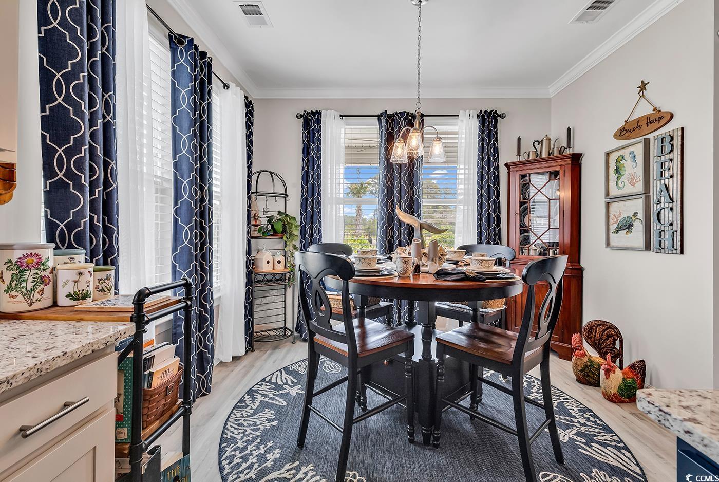 296 Switchgrass Loop Little River, SC 29566 - Photo 16 of 40 Dining room with crown molding, light wood finishe