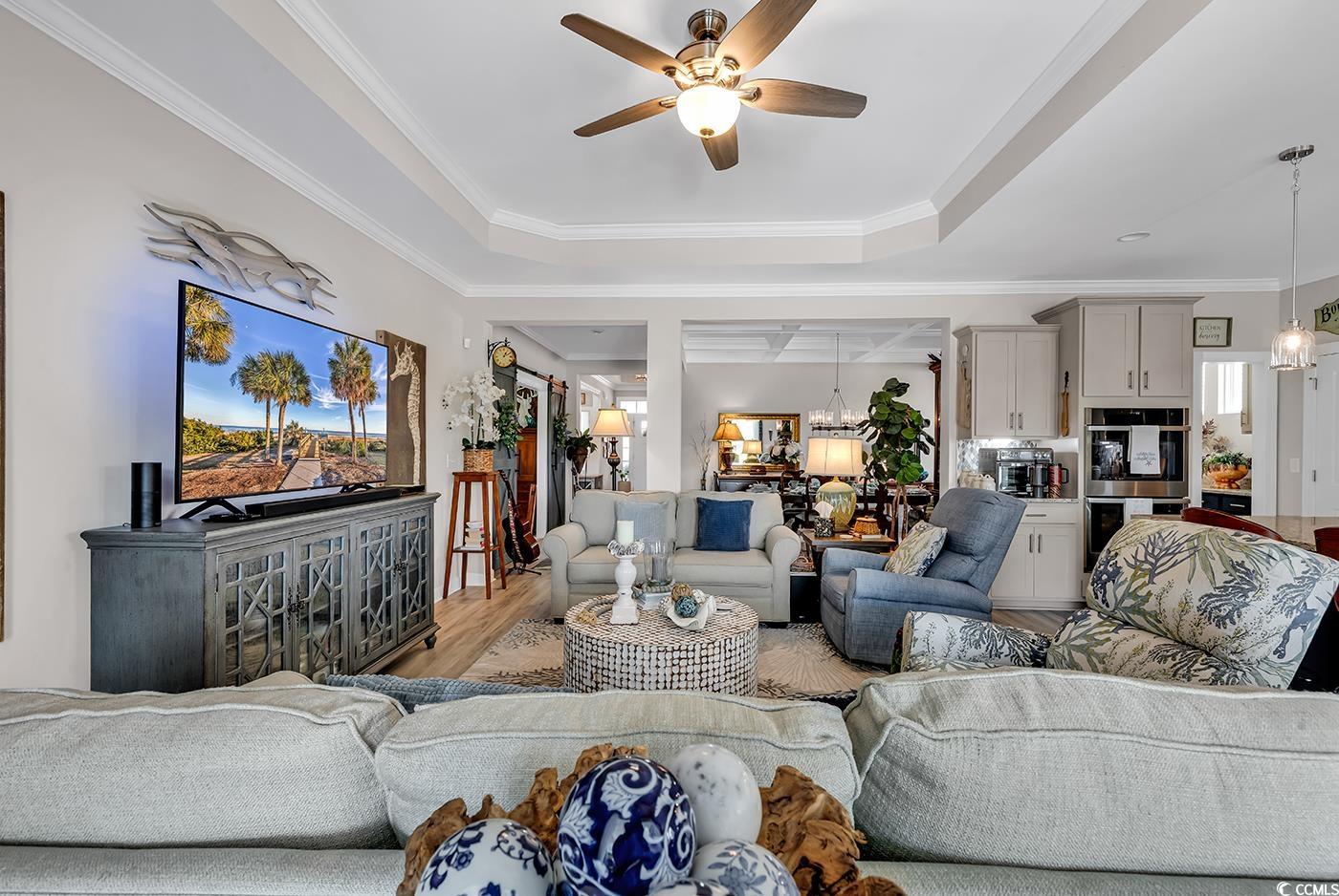 296 Switchgrass Loop Little River, SC 29566 - Photo 18 of 40 Living area featuring a tray ceiling, light wood f