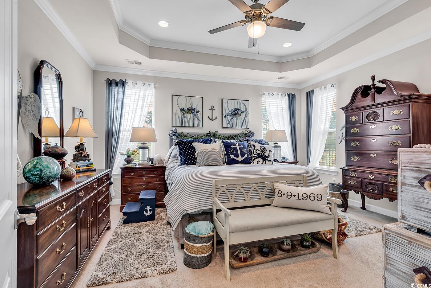 296 Switchgrass Loop Little River, SC 29566 - Photo 19 of 40 Bedroom with a raised ceiling, multiple windows, a