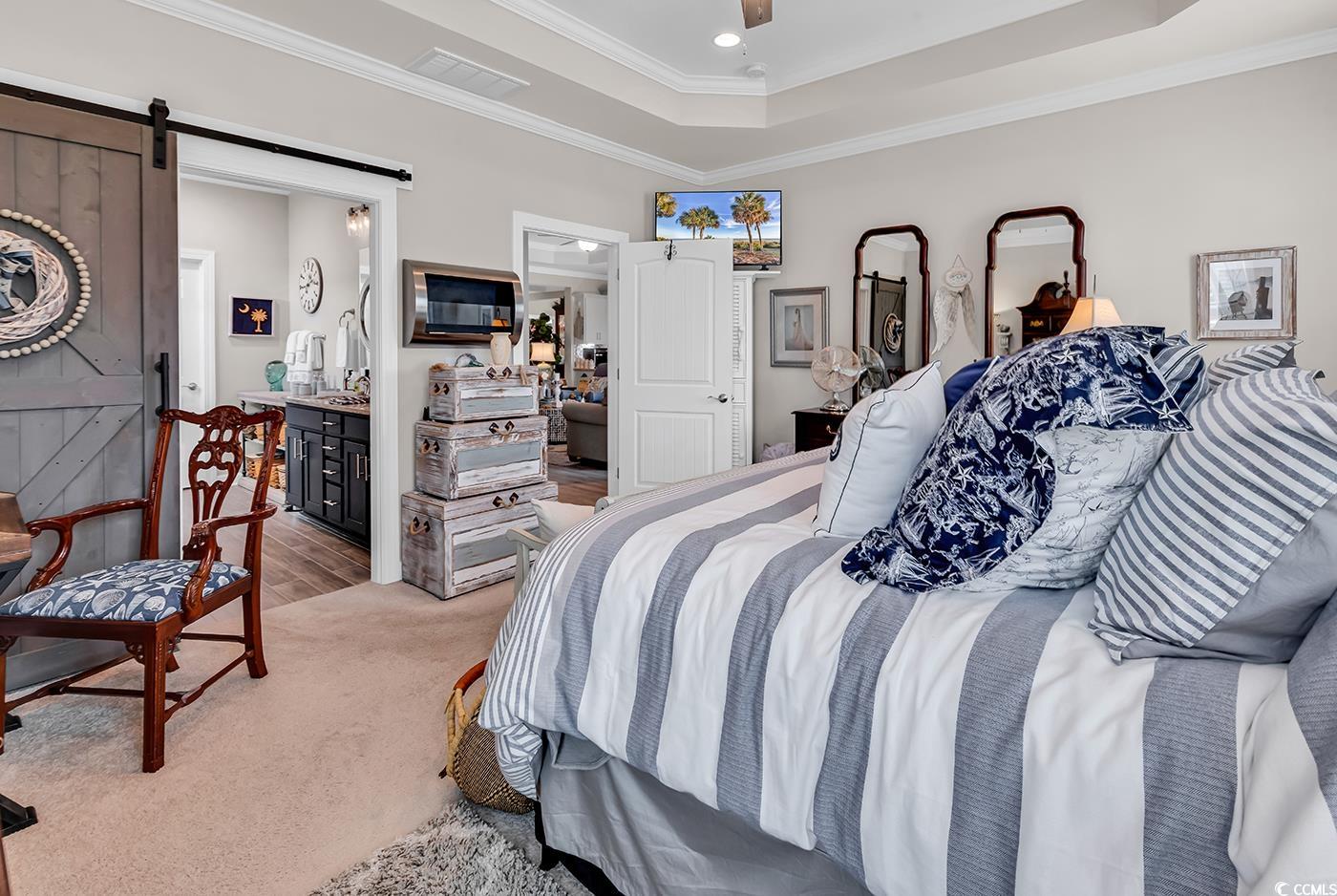 296 Switchgrass Loop Little River, SC 29566 - Photo 20 of 40 Bedroom with visible vents, a barn door, ornamenta