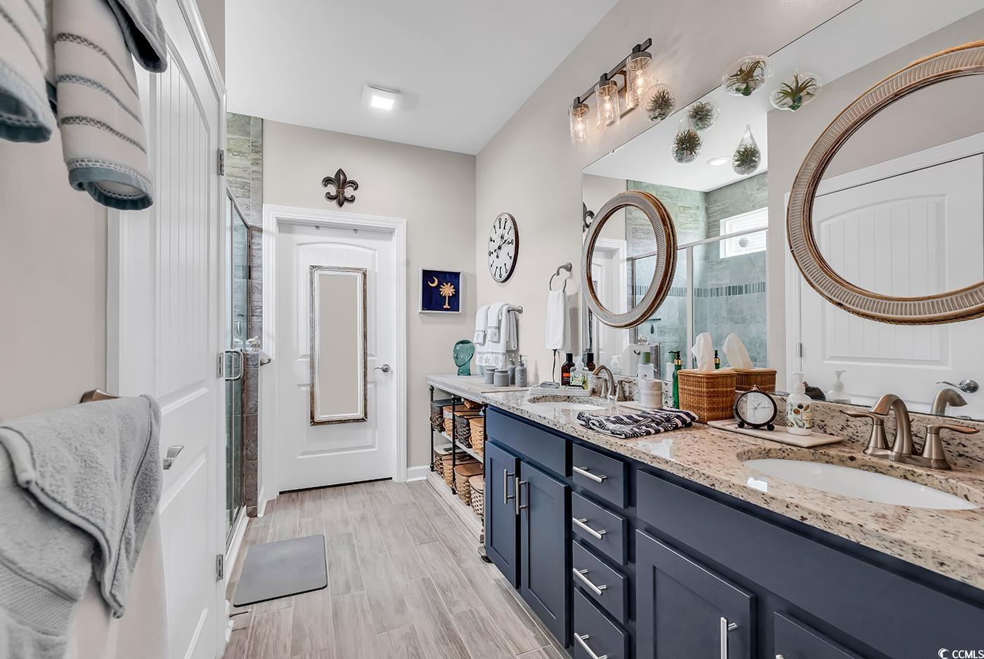 296 Switchgrass Loop Little River, SC 29566 - Photo 21 of 40 Full bathroom featuring a stall shower, wood finis