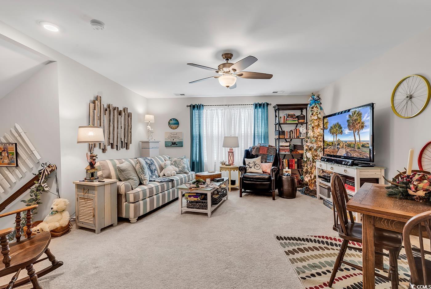 296 Switchgrass Loop Little River, SC 29566 - Photo 24 of 40 Carpeted living room featuring ceiling fan