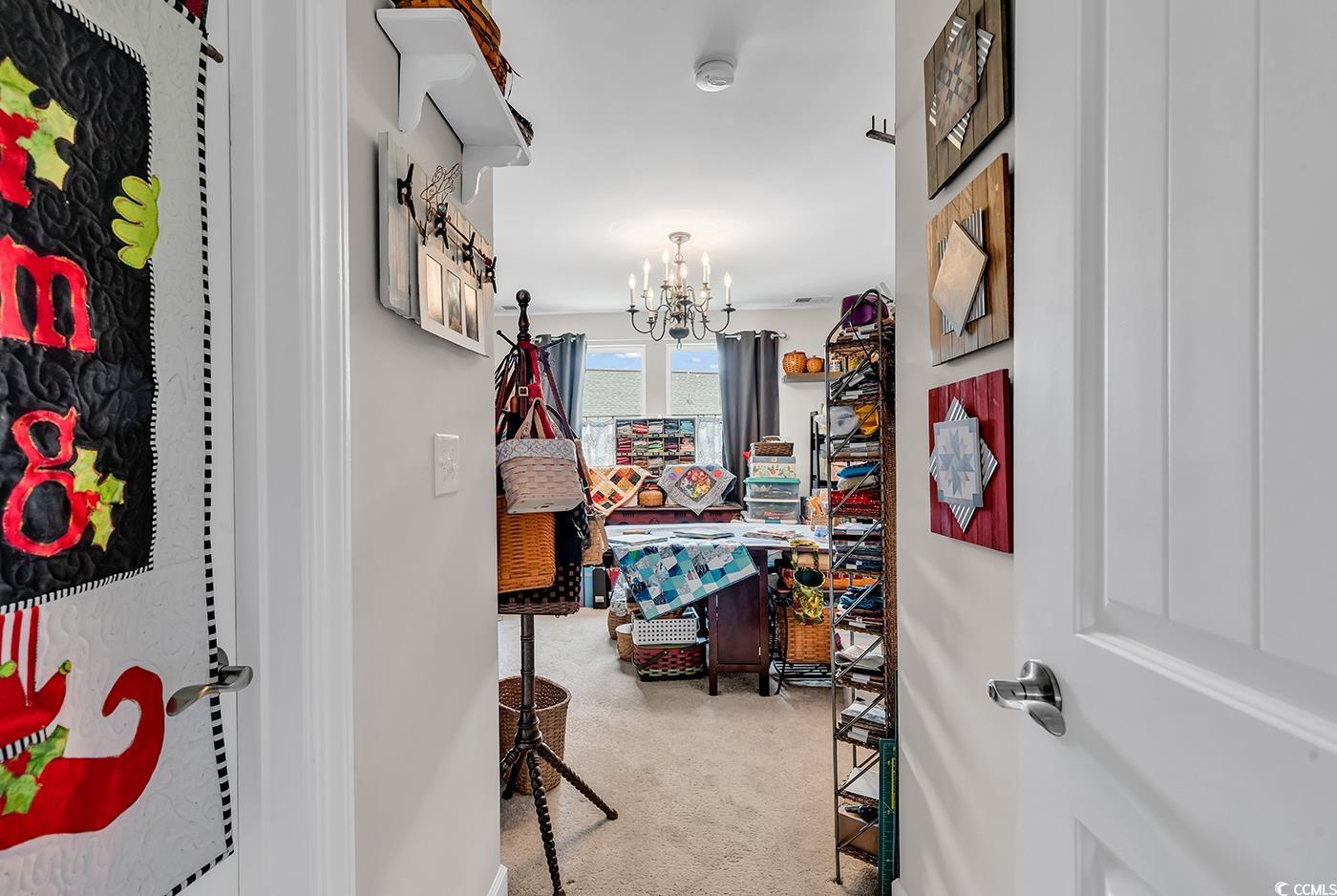 296 Switchgrass Loop Little River, SC 29566 - Photo 25 of 40 Hall featuring a chandelier and carpet floors