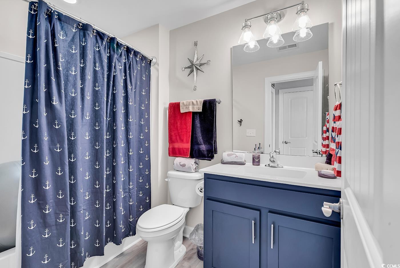 296 Switchgrass Loop Little River, SC 29566 - Photo 26 of 40 Bathroom with toilet, wood finished floors, vanity