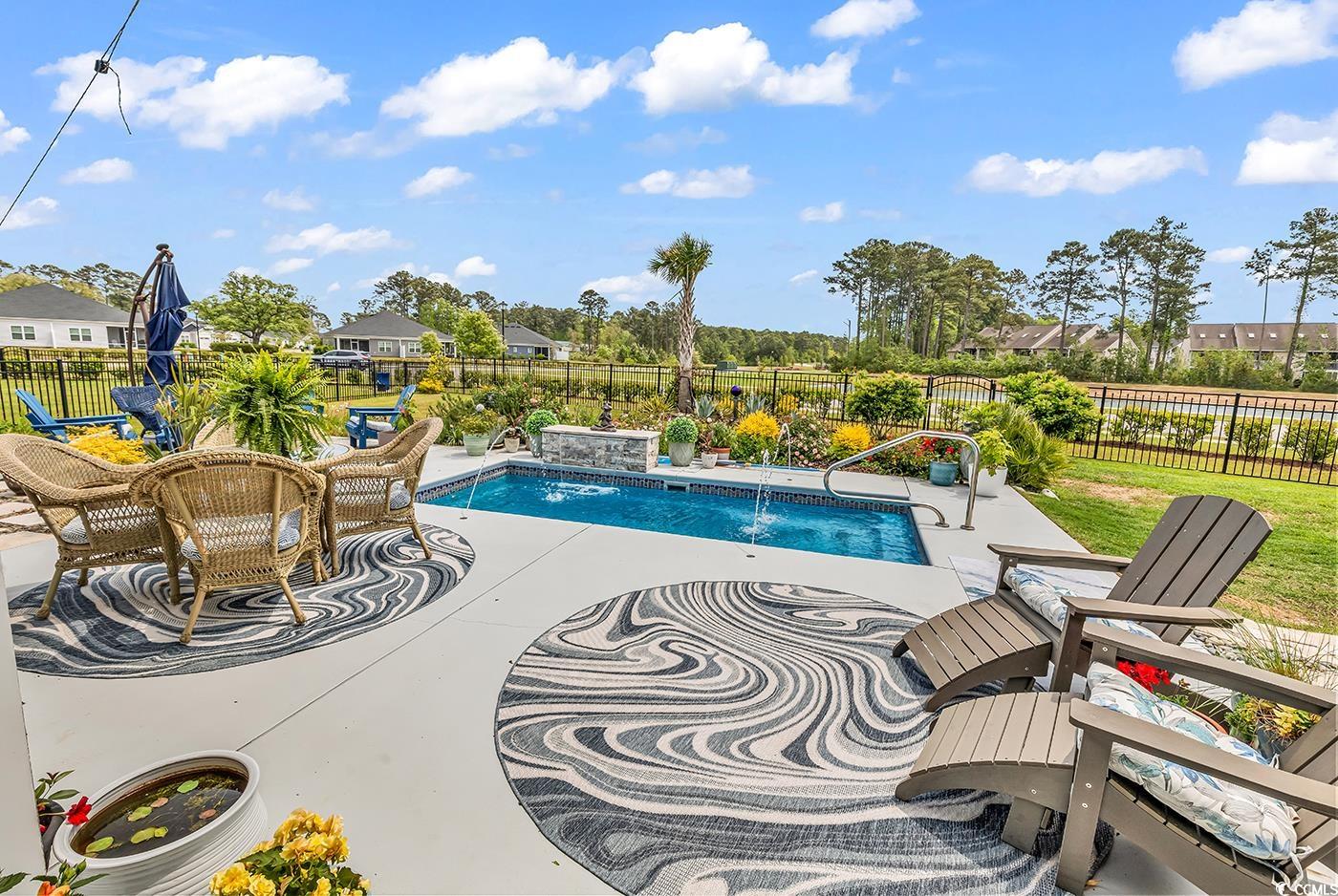 296 Switchgrass Loop Little River, SC 29566 - Photo 28 of 40 View of swimming pool with a patio area, a fenced
