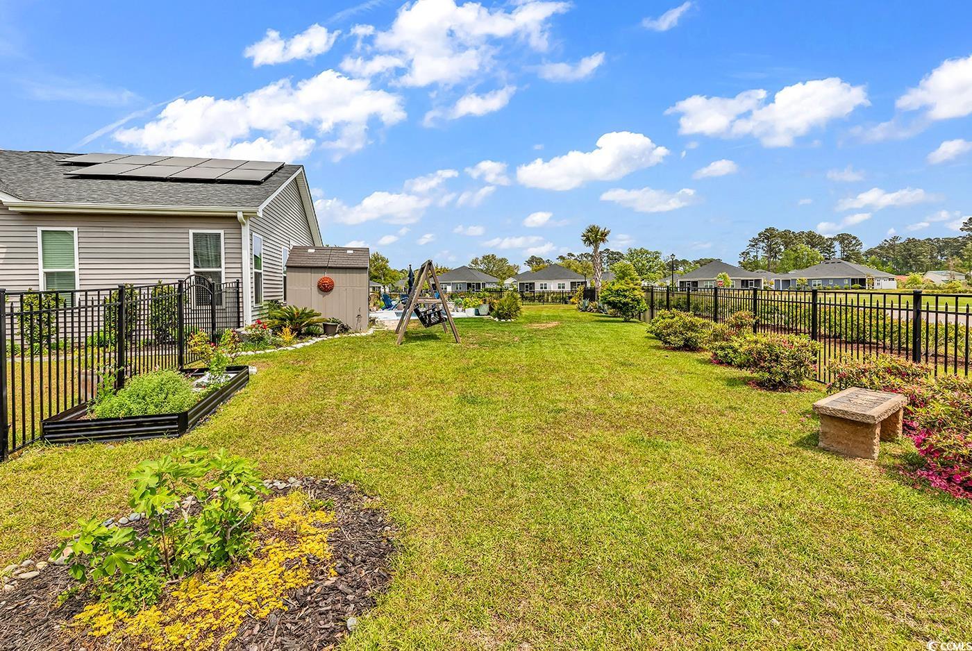 296 Switchgrass Loop Little River, SC 29566 - Photo 32 of 40 View of yard with a garden, a storage shed, a fenc