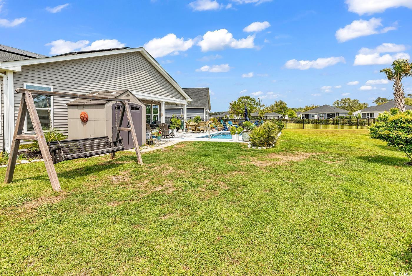 296 Switchgrass Loop Little River, SC 29566 - Photo 33 of 40 View of yard featuring fence, a patio, a storage u