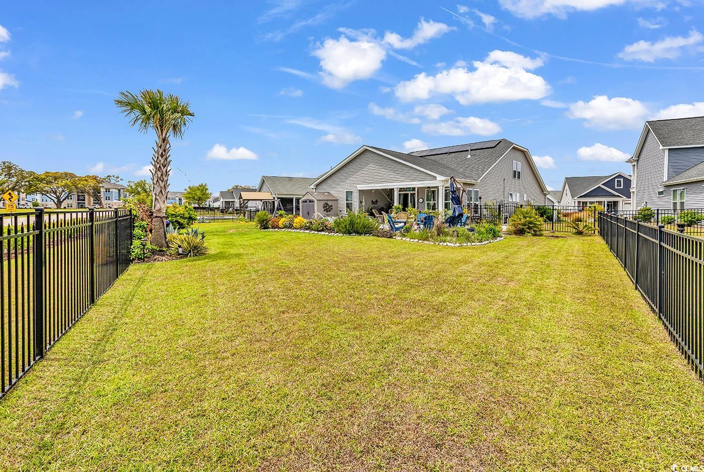 296 Switchgrass Loop Little River, SC 29566 - Photo 34 of 40 View of yard featuring a fenced backyard and a res